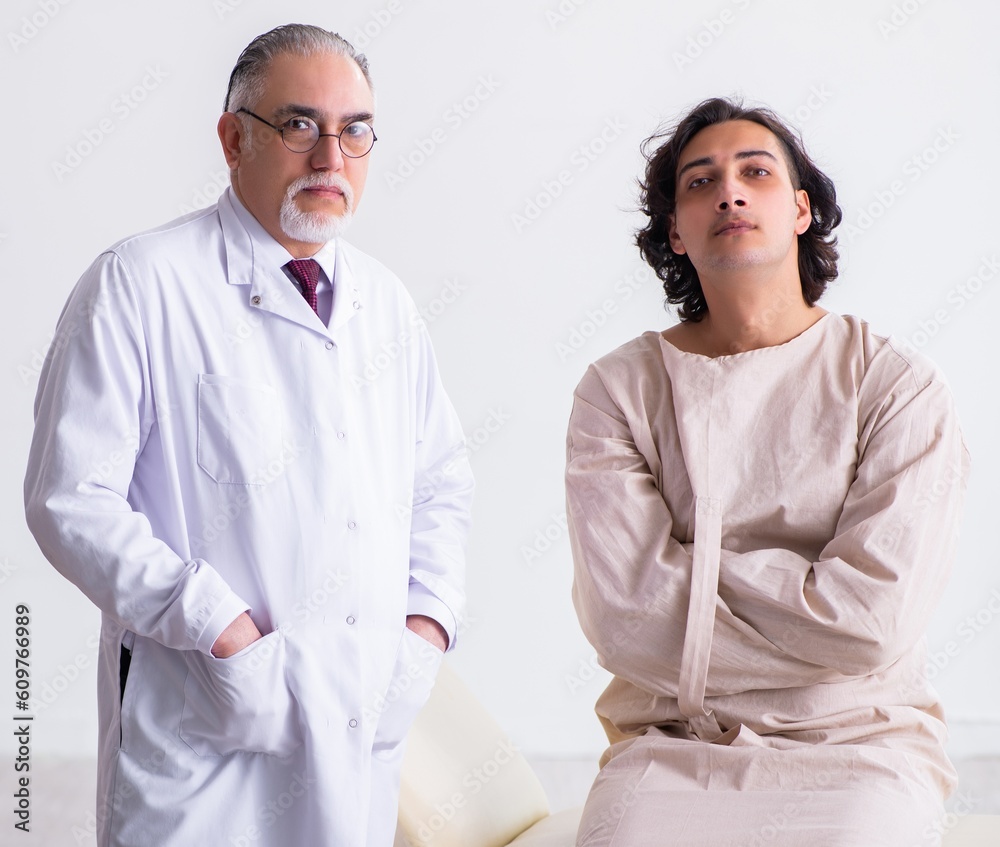 Aged male doctor psychiatrist examining young patient Aged male doctor psychiatrist examining young patient
