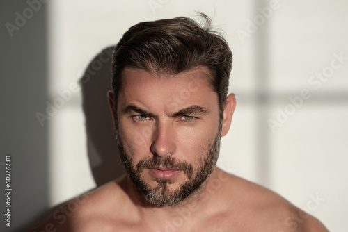 Close up face of handsome man. Portrait of shirtless man for skincare and beauty concepts. Handsome man with beauty face, facial skin portrait. Male healthy skin and spa concept.