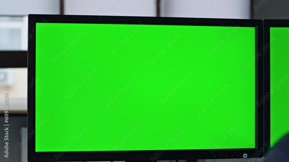 Closeup chromakey screen in office. It manager working on template computer Closeup chromakey screen in office. It manager working on template computer