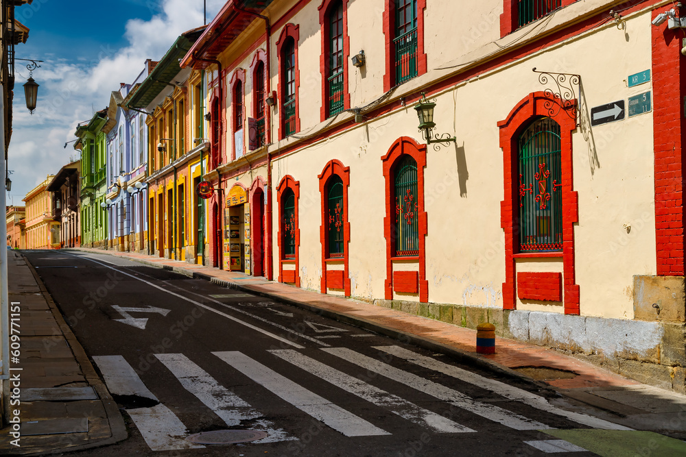 Fototapeta premium Empty street with colorful buildings in La Candelaria district in Bogota, Colombia