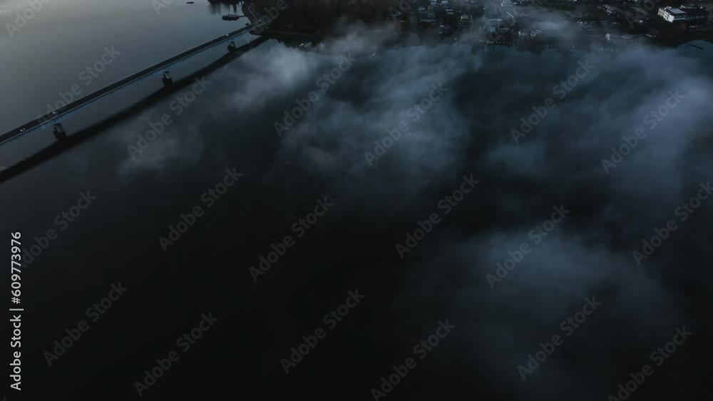 Low hanging clouds above the Kawaguchi lake and the Fujikawaguchiko village, sunrise in Japan - Aerial tilt shot Low hanging clouds above the Kawaguchi lake and the Fujikawaguchiko village, sunrise in Japan - Aerial tilt shot