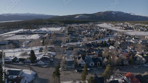 Leadville Aerial cinematic drone Colorado historic downtown winter spring snowy street buildings late afternoon early evening blue sky bright sunshine forward pan up reveal movement photo