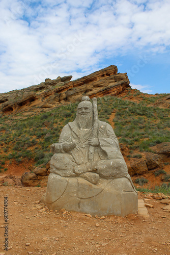 Statue of the White Elder against summer mountain landscape in Bogdo Baskunchak Nature Reserve. photo