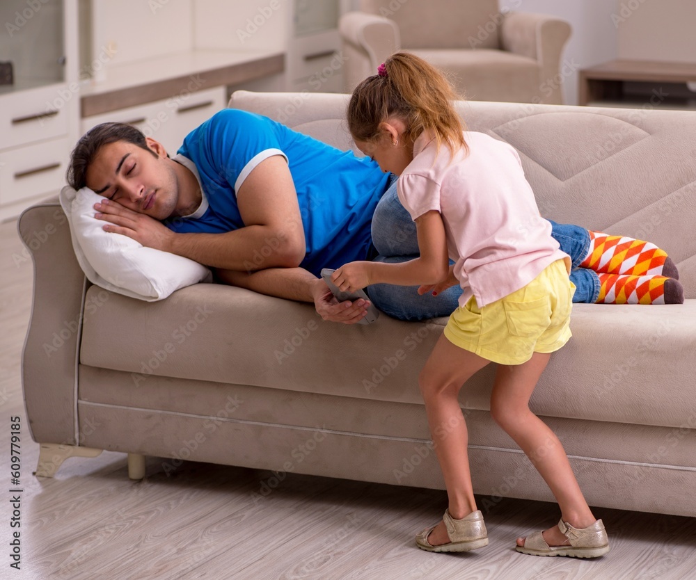 Young man with his daughter at home Young man with his daughter at home