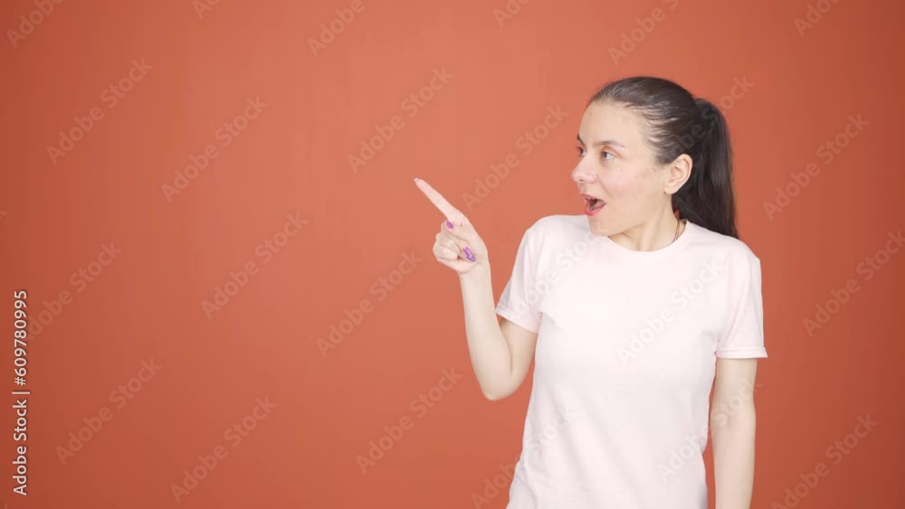 The woman promoting is looking at the camera in surprise.