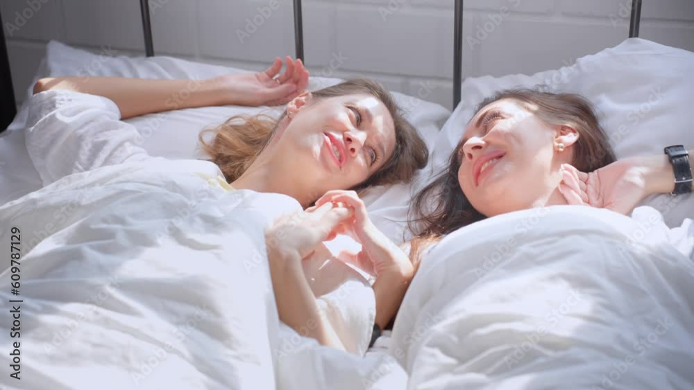 Asian beautiful lesbian couple lying on bed and looking at each other. Asian beautiful lesbian couple lying on bed and looking at each other.