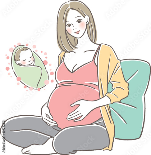 赤ちゃんを想像してお腹に手を当て微笑む妊婦