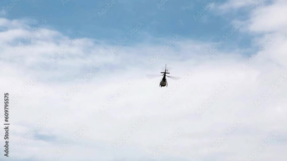Handheld Shot Of Helicopter Flying In Blue Sky With White Clouds Away From Camera
Handheld Shot Of Helicopter Flying In Blue Sky With White Clouds Away From Camera
