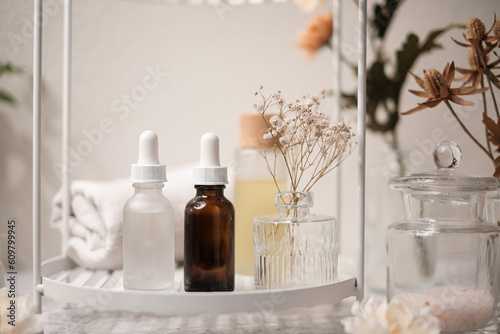 skincare serum and beauty products on the shelf in the bathroom. cosmetic and self care concept.