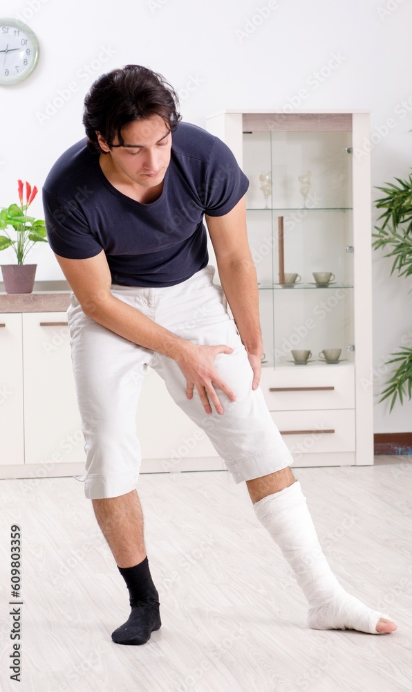 Leg injured young man suffering at home Leg injured young man suffering at home