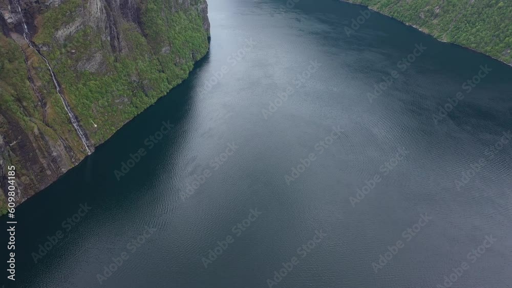 Geiranger aerial with slow tilt up from beautiful Unesco fjord to revealing seven sisters waterfall during spring - Norway Geiranger aerial with slow tilt up from beautiful Unesco fjord to revealing seven sisters waterfall during spring - Norway