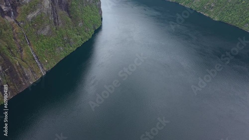 Geiranger aerial with slow tilt up from beautiful Unesco fjord to revealing seven sisters waterfall during spring - Norway photo