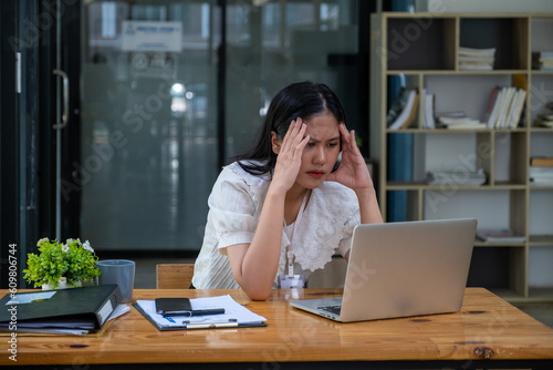 Stressed angry unwell woman working in office looking at laptop computer, Business officer employee manager woman unhappy serius unjoyful with her law firm ecommerce her business owner