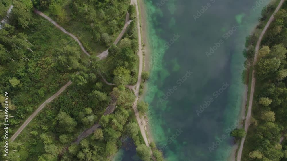 Top down shot of Lake Bluntausee golling with person riding a bike, aerial 4k