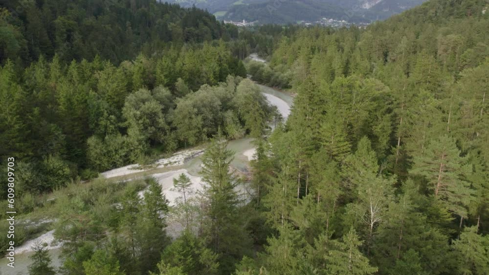 Drone flies over a amazing green scenery of lake Bluntausee in austria, aerial 4k