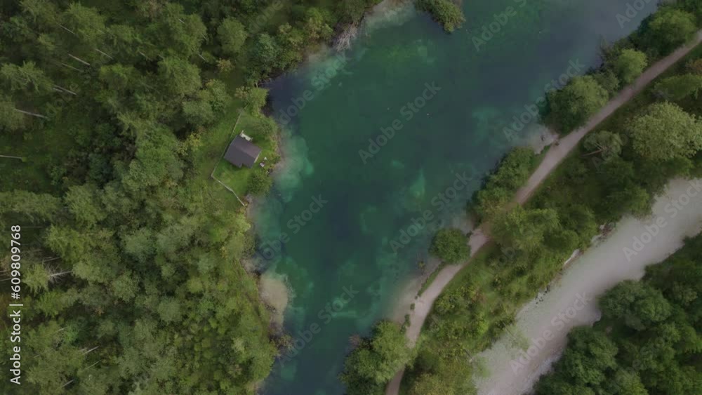 Small mountain hut next to a blue lake at Austria, top down