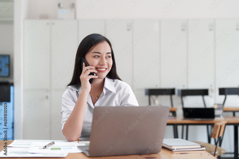 Beautiful business woman talking on the mobile phone. Management, planning and networking phone call concept Beautiful business woman talking on the mobile phone. Management, planning and networking phone call concept