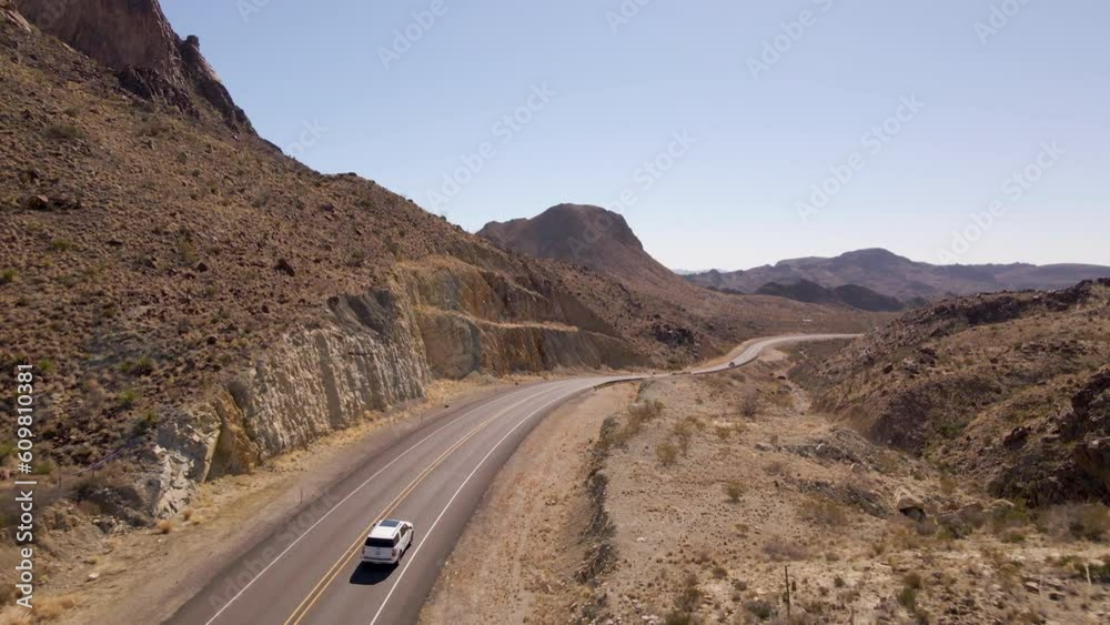 Aerial Drone Fly Above Road Between Desert Road Deep Canyons, Dry Landscape of Big Bend National Park, Texas, United States. Drive car in the desert road Aerial Drone Fly Above Road Between Desert Road Deep Canyons, Dry Landscape of Big Bend National Park, Texas, United States. Drive car in the desert road