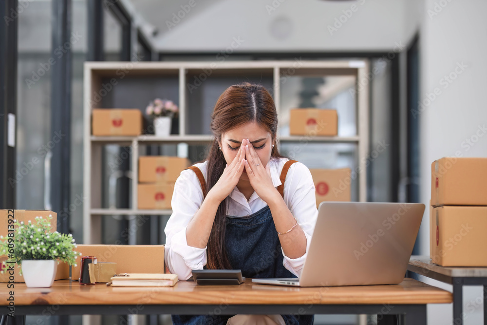 Small Business, Startup SME, Owner Entrepreneurs. Asian woman with unsuccess business online shopping crying and serious face unhappy mood. Small Business, Startup SME, Owner Entrepreneurs. Asian woman with unsuccess business online shopping crying and serious face unhappy mood.