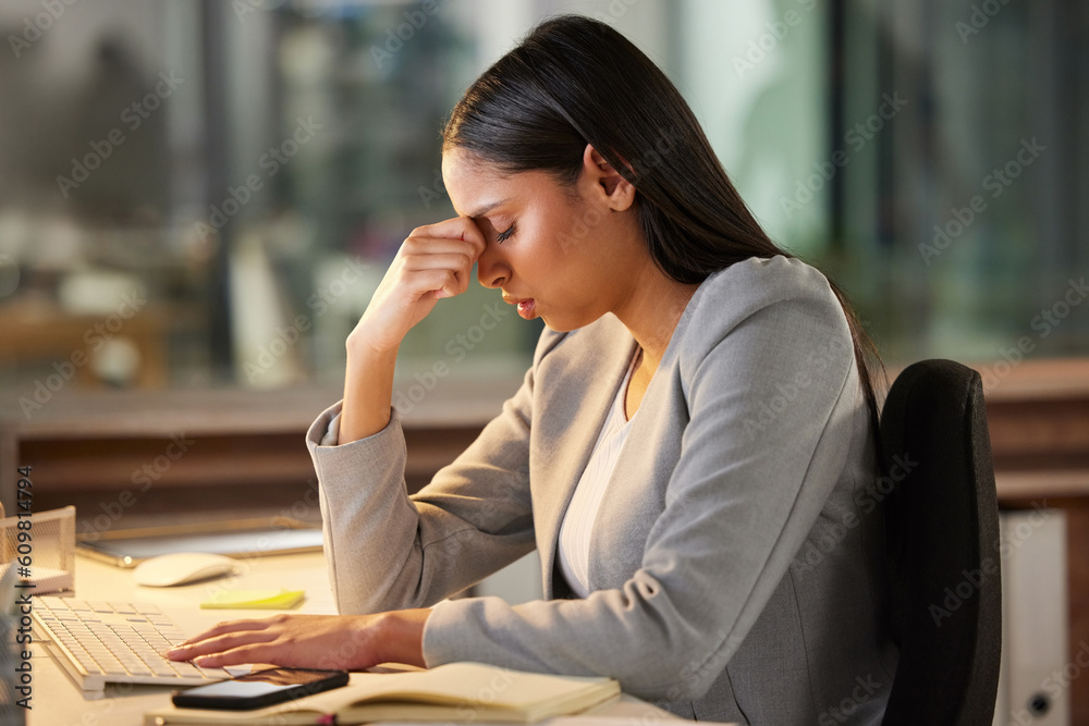 Fototapeta premium Headache, stress and sad business woman in night office for burnout, fatigue or mental health problem. Crisis, pain and depressed or tired professional person at desk for mistake, depression or fail