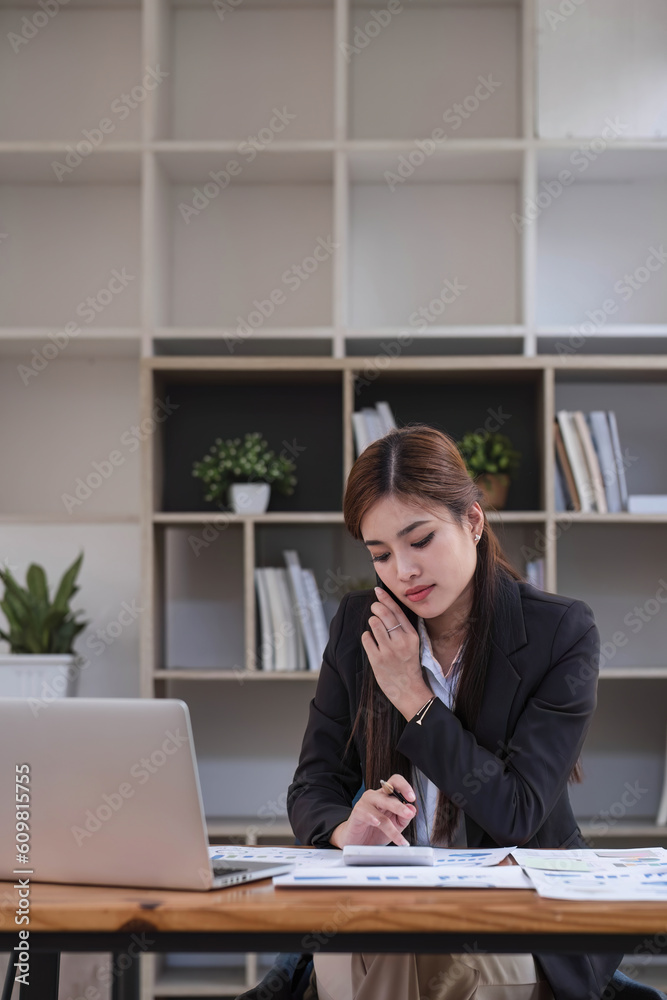 Asian businesswoman in formal suit in office happy and cheerful during using smartphone and working