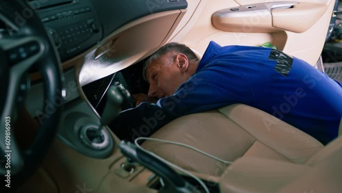 Auto mechanic changing the air filter in the cabin of a luxury car Concept of caring for expensive cars and loving used cars