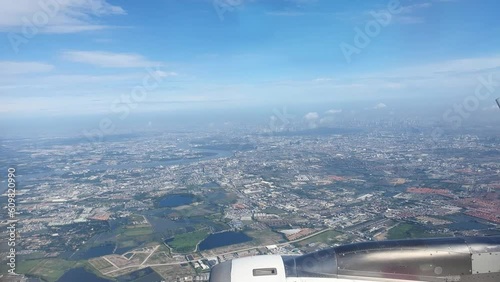 Spectacula green City Landscape view from airplane window, aerial view, clear sky daylight, Cityscape, flying at high altitude, high quality footage photo