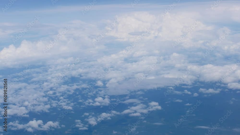 White fluffy clouds view from the window of an aircraft. Aerial view, flying in a plane at high altitude, High quality footage White fluffy clouds view from the window of an aircraft. Aerial view, flying in a plane at high altitude, High quality footage
