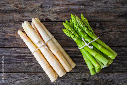 Bunch of white and green asparagus on wooden background
