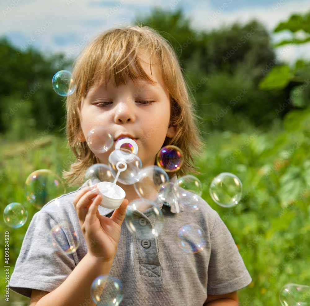 Happy Boy play in bubbles in field sunny summer day. Happy Boy play in bubbles in field sunny summer day.