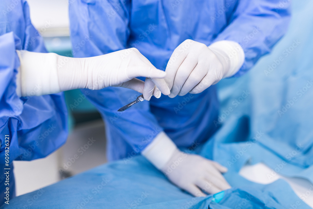 Shot in the Operating Room, Assistant Hands out Instruments to Surgeons During Operation. Surgeons Perform Operation. Professional Medical Doctors Performing Surgery. Shot in the Operating Room, Assistant Hands out Instruments to Surgeons During Operation. Surgeons Perform Operation. Professional Medical Doctors Performing Surgery.
