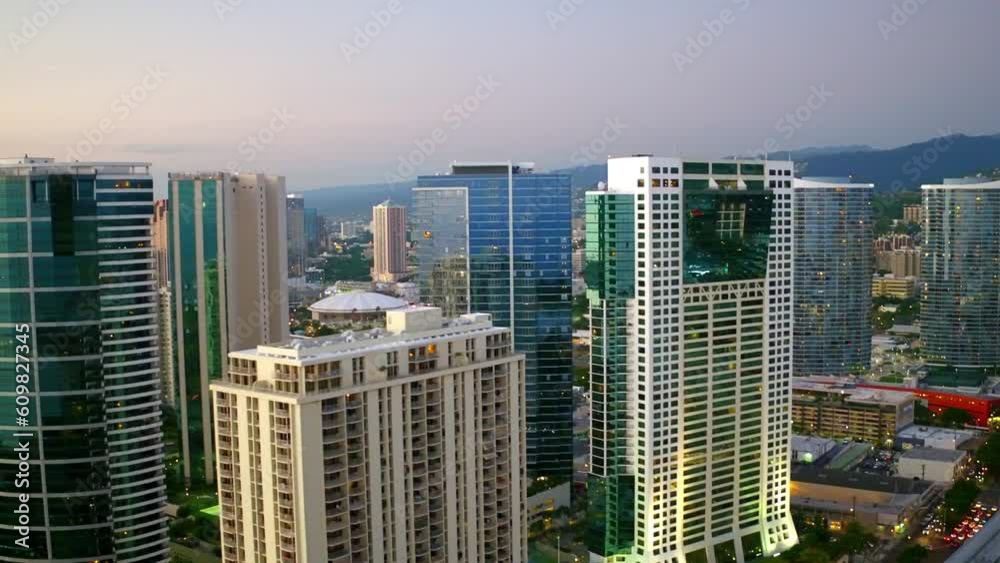 Aerial Panning Shot Of Modern Buildings In A City Against Sky At Sunset, Drone Flying Over Cityscape - Oahu, Hawaii Aerial Panning Shot Of Modern Buildings In A City Against Sky At Sunset, Drone Flying Over Cityscape - Oahu, Hawaii