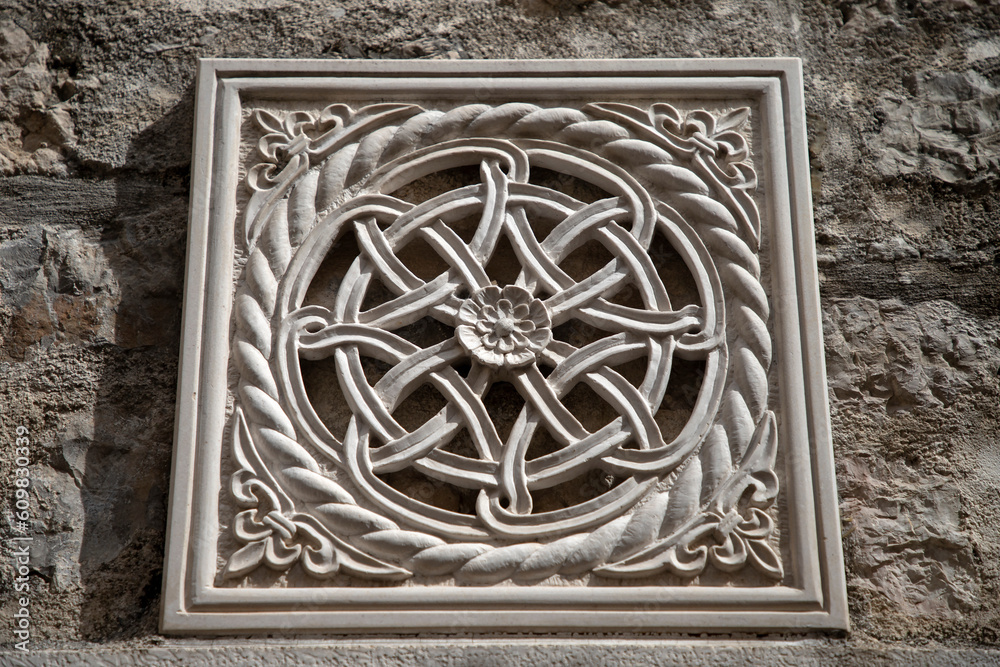 Kotor, Montenegro - Detail of carved stone decoration on an ancient house wall