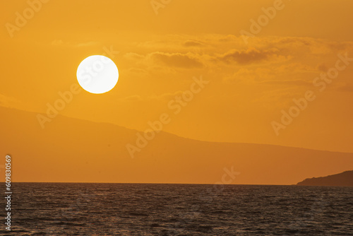 Magical golden sunset from Maui beach  sea and mountain background. 