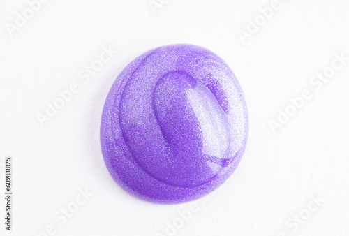 Lilac cosmetic cream smear on white background. Violet beauty cream smear swipe swatch closeup. Lavender face serum, lotion, moisturizer on white. Light purple paint swatch