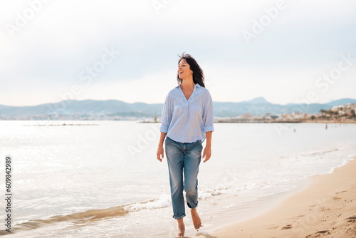 Mature woman walking at beach