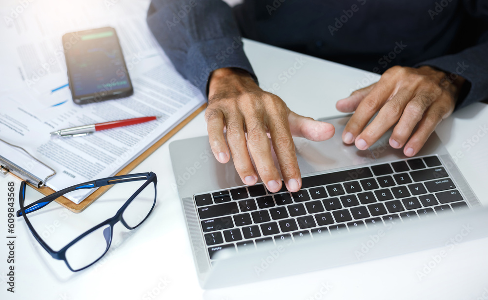 Asian business man working on laptop computer reading email and meeting online with business group, analysis investment plan with chart and review business contract Asian business man working on laptop computer reading email and meeting online with business group, analysis investment plan with chart and review business contract