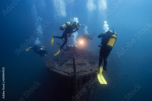 Men and women examining El Naranjito sunken ship undersea photo