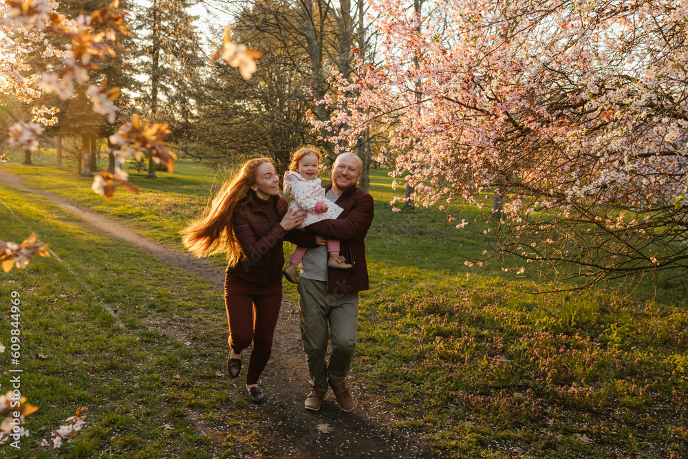 Happy family running with daughter at park Happy family running with daughter at park