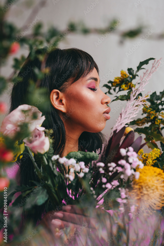 Young woman with eyes closed amidst colorful flowers Young woman with eyes closed amidst colorful flowers