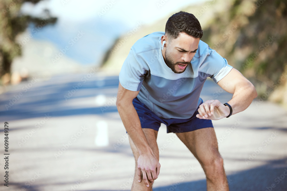 Fototapeta premium Man, fitness and outdoor with a watch for a run or exercise with performance progress. Tired athlete person or runner on a road with time and music for training, running or health and wellness goals