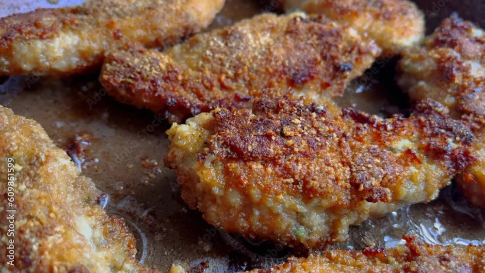 Delicious chicken nuggets frying on hot oil pan. Homemade cooking breaded cutlets is steaming Delicious chicken nuggets frying on hot oil pan. Homemade cooking breaded cutlets is steaming