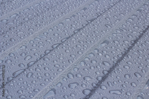 drops of water on the surface of a metal sheet,the roof is covered with drops of rain, rain on a corrugated metal sheet