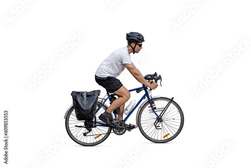 Cyclist riding a touring bicycle equipped with panniers - isolated from background photo