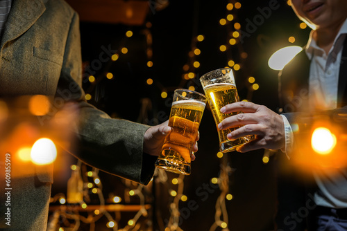 food and drink male friends are happy drinking beer and clinking glasses at a bar or pub.