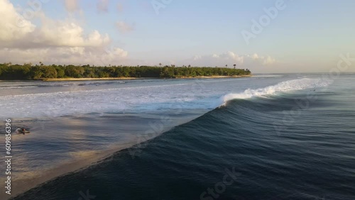 Huge ocean wave crashes into a surfer at G-Land, Grajagan Bay, Plengkung Beach, Java, Indonesia, slow motion, close up photo