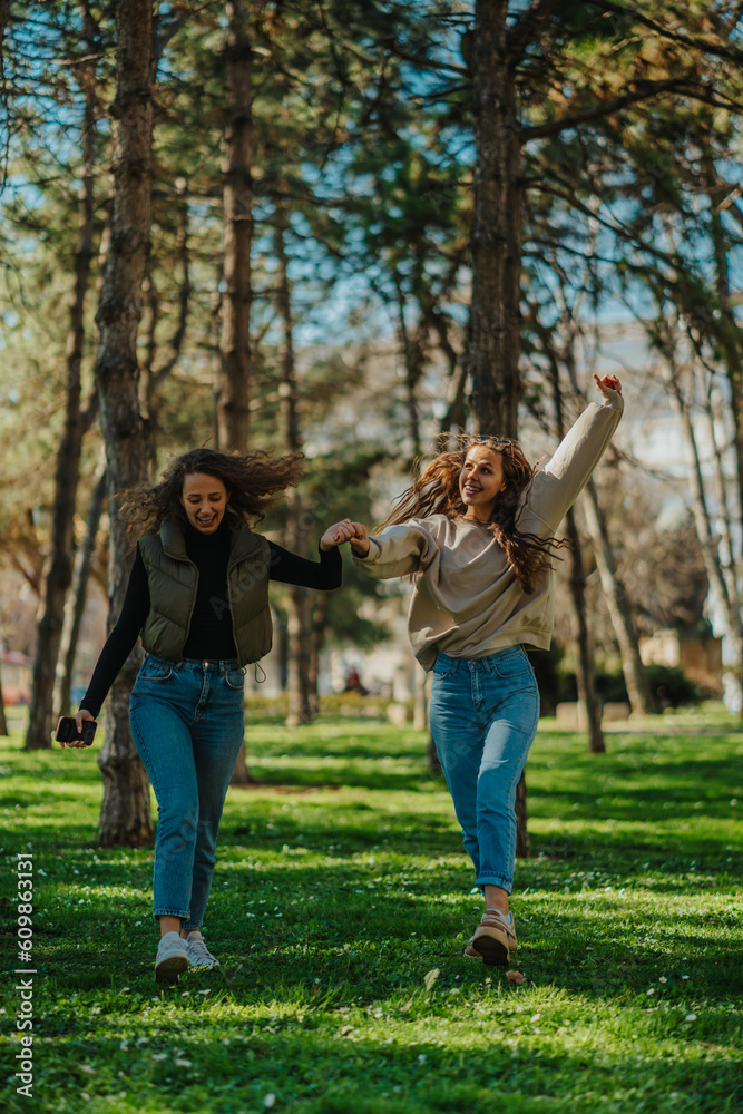 Two happy, smiley, gorgeous girls, dancing while walking in the park