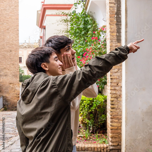 Younger brother points older brother to a place, older brother is surprised