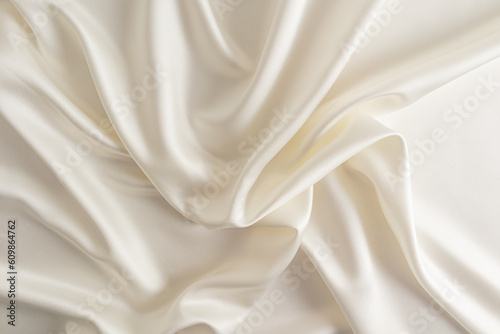 Chic beige or champagne satin fabric for wedding design. abstract background. soft delicate folds of fabric.