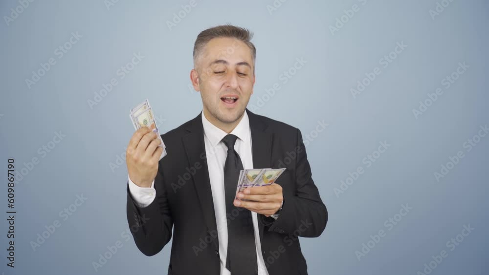 Businessman counting money looking at camera. Businessman counting money looking at camera.